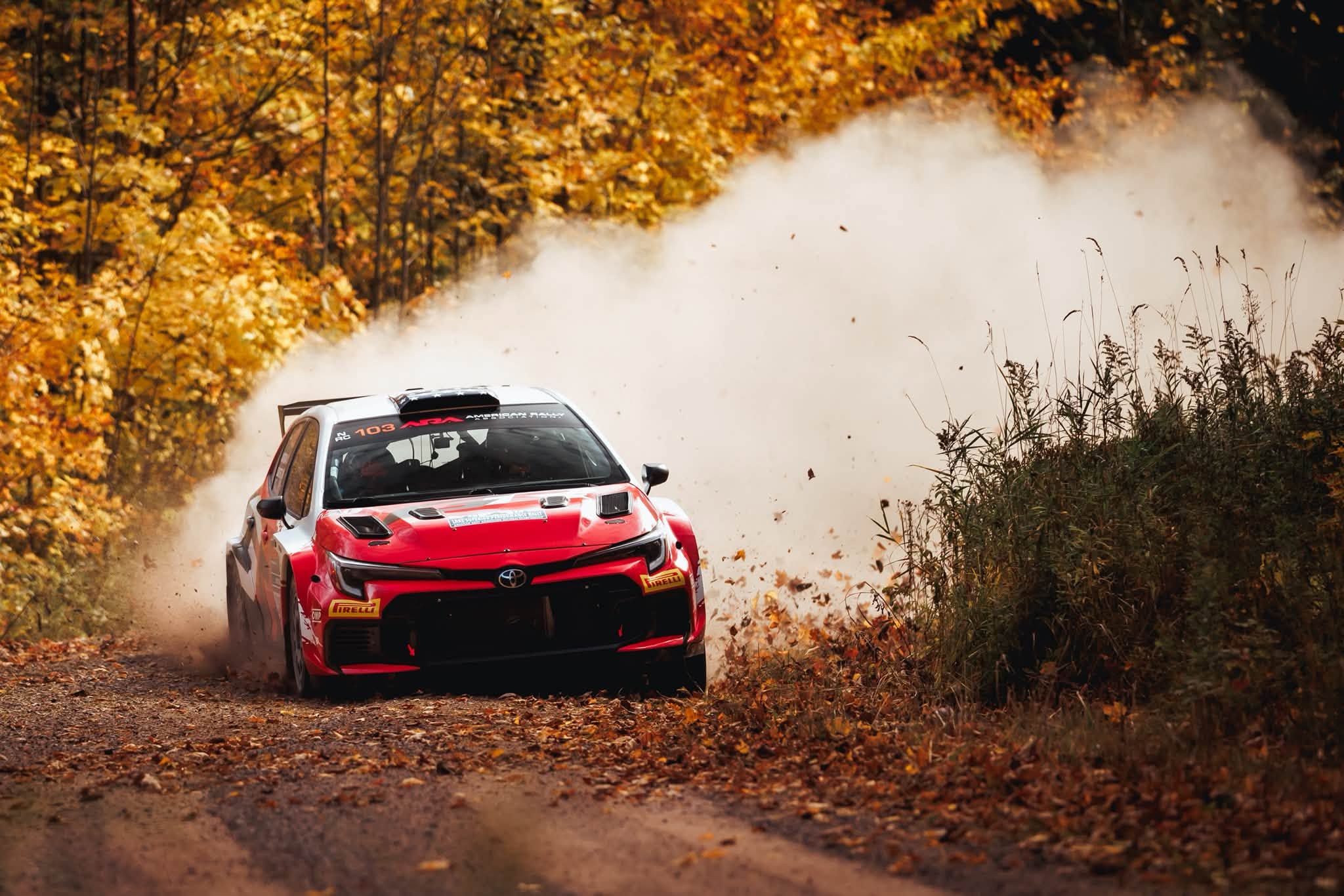 Seth Quintero’s Toyota GR Corolla Rally RC2 sliding through autumn leaves at the Lake Superior Performance Rally