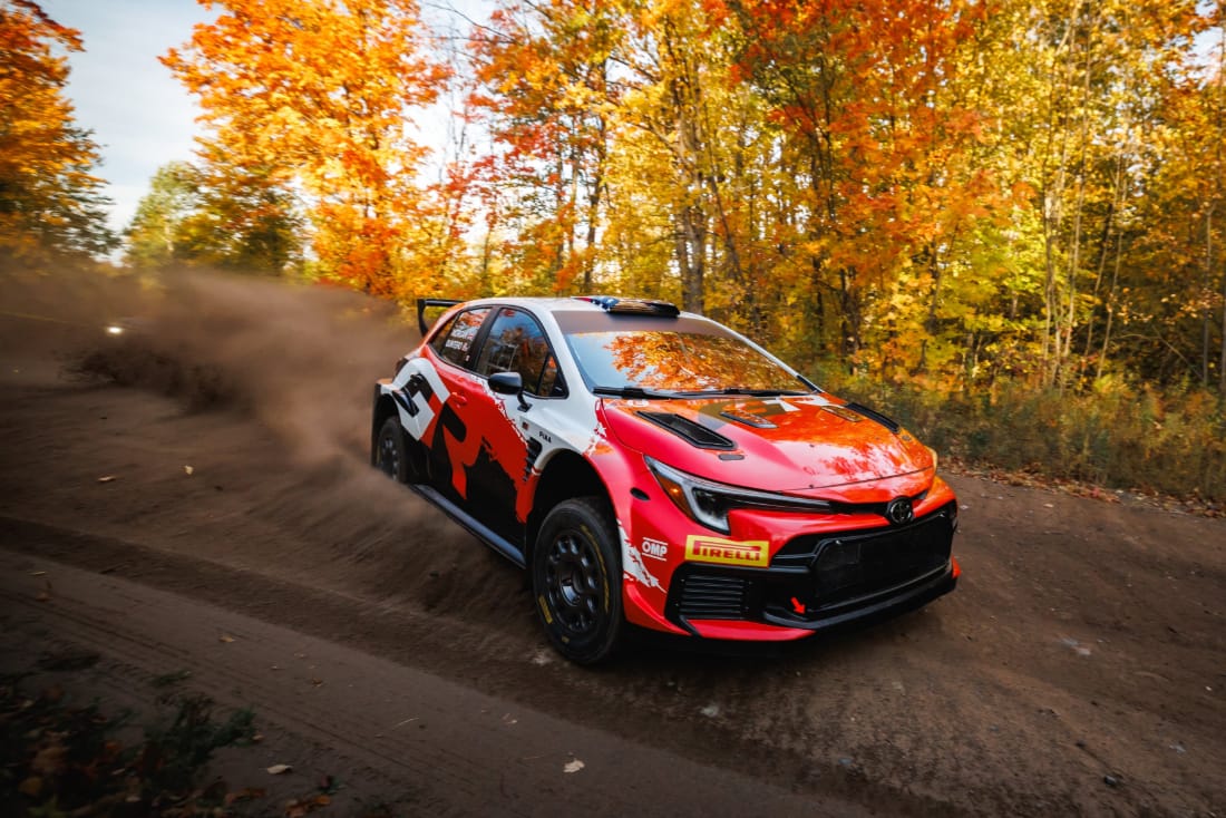 Seth Quintero’s Toyota GR Corolla Rally RC2 cornering on a gravel stage lined with autumn trees