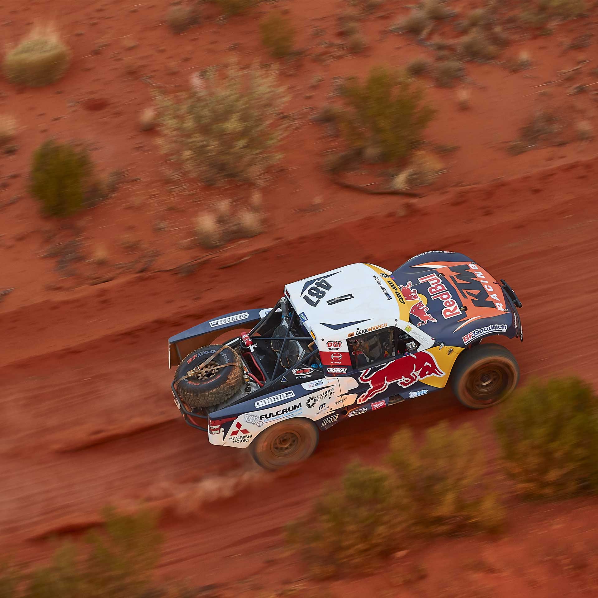 Toby Price's Trophy Truck at speed on the red dirt