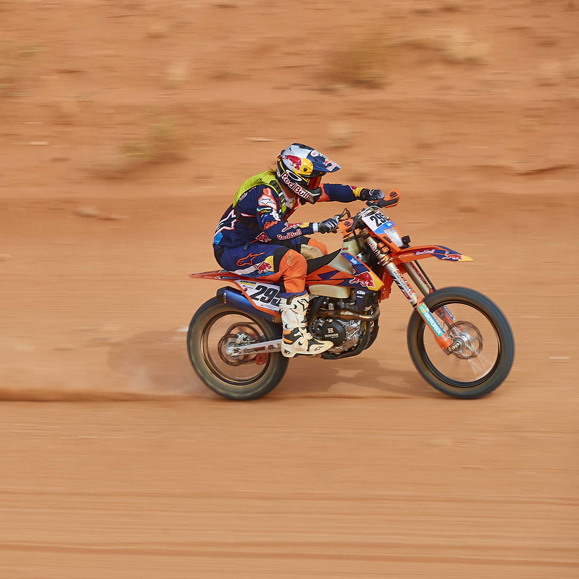 Toby Price racing his KTM across the desert sand