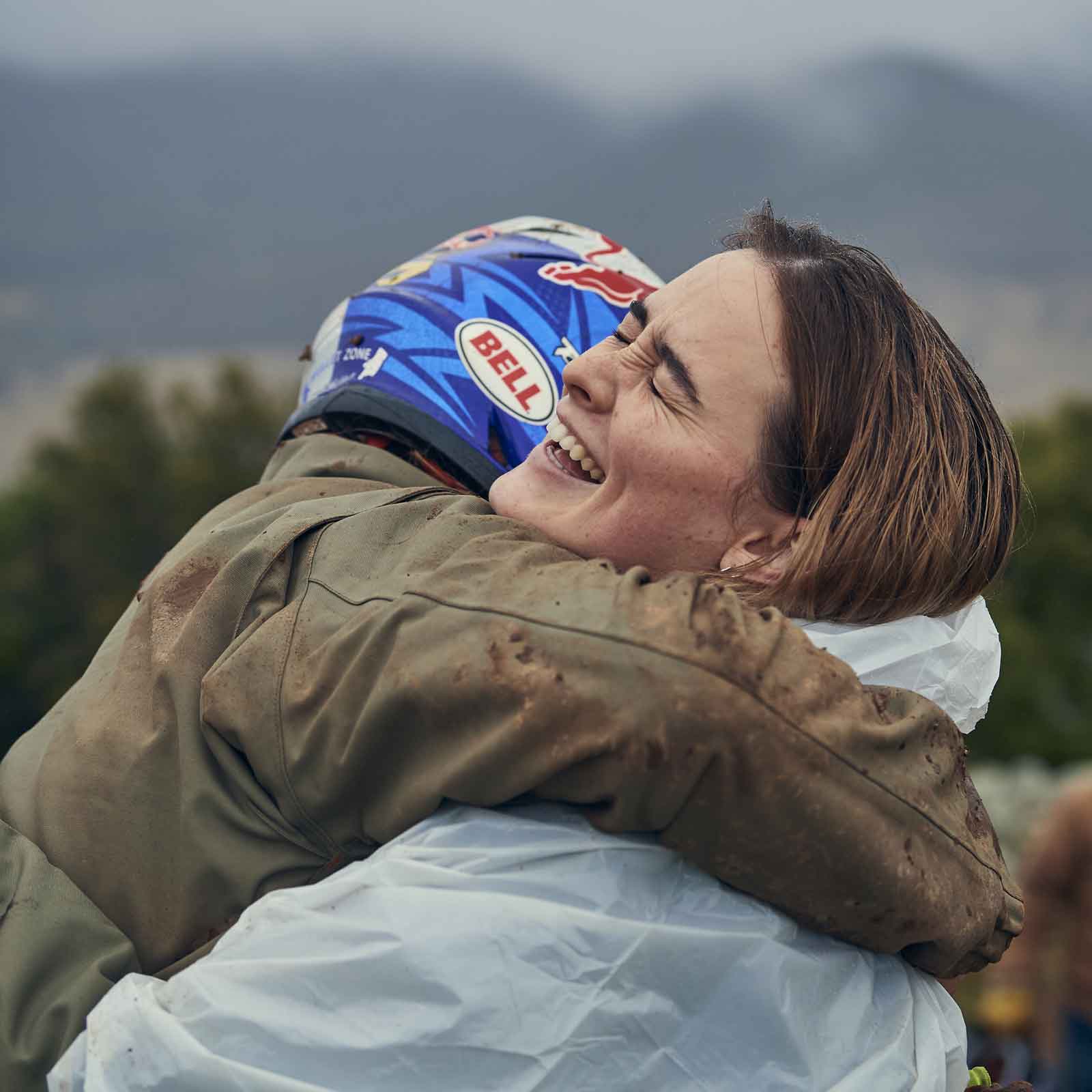 A rider hugging a crew member after a session