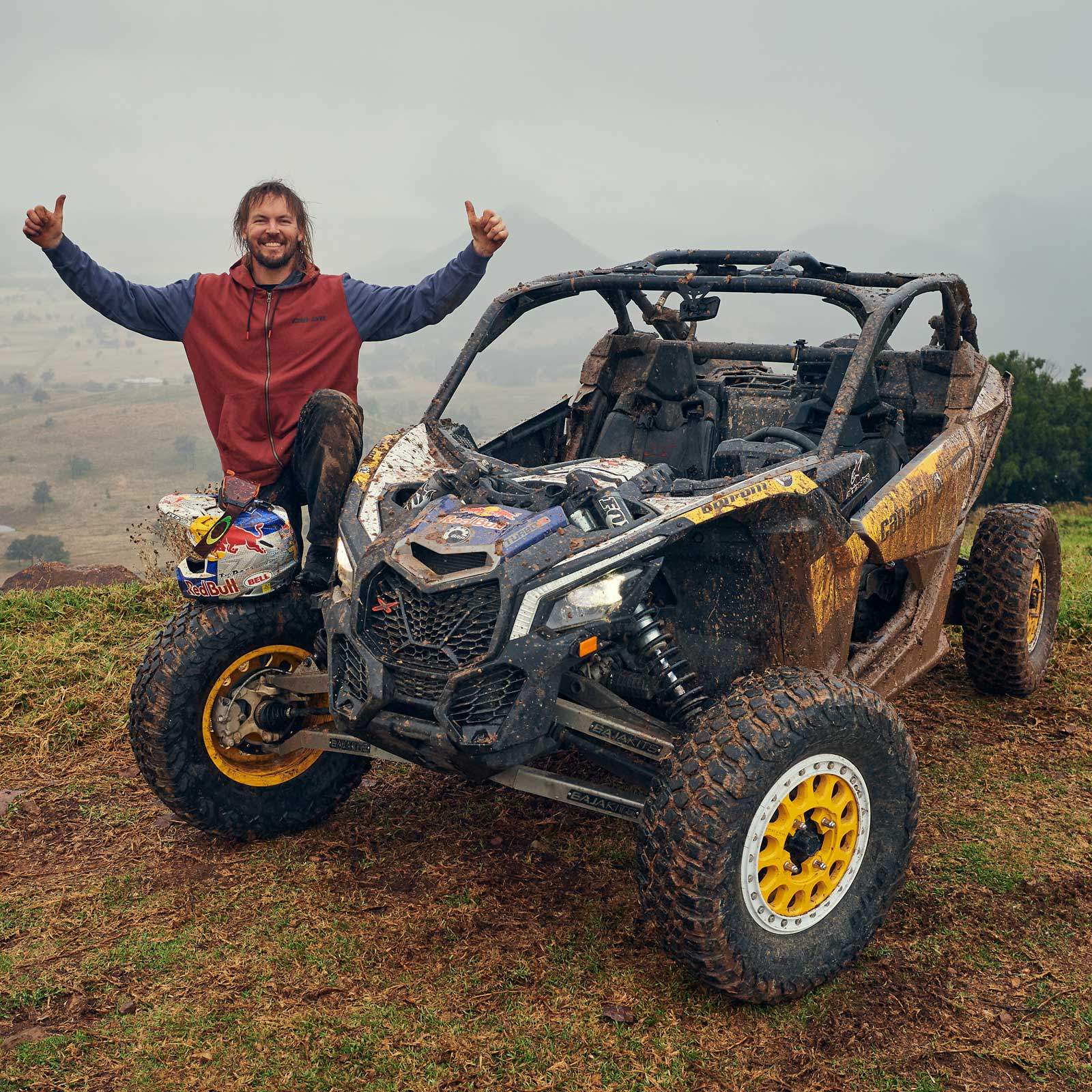 Toby Price celebrating beside a Can-Am Maverick X3