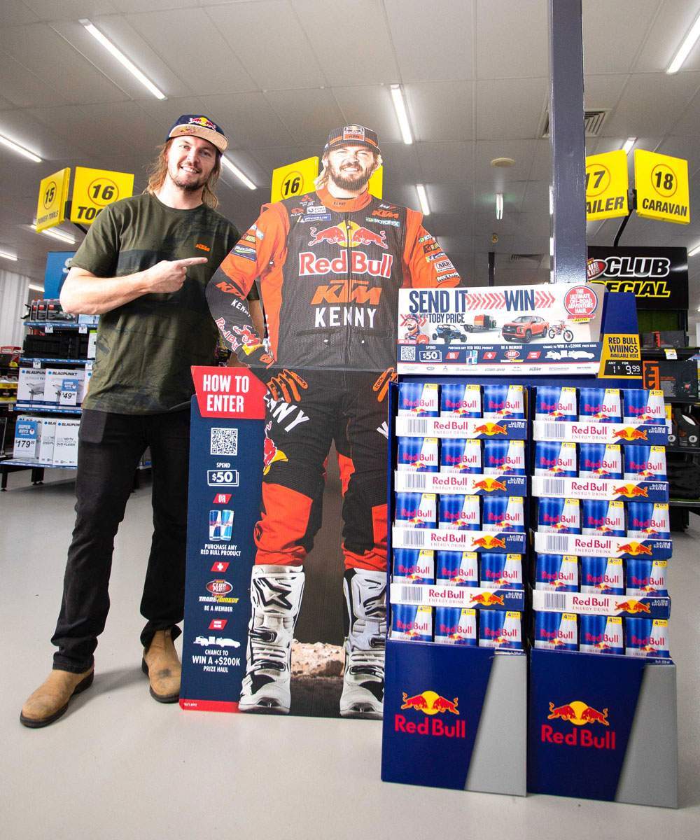 Toby Price beside the Send It with Toby Price in-store display