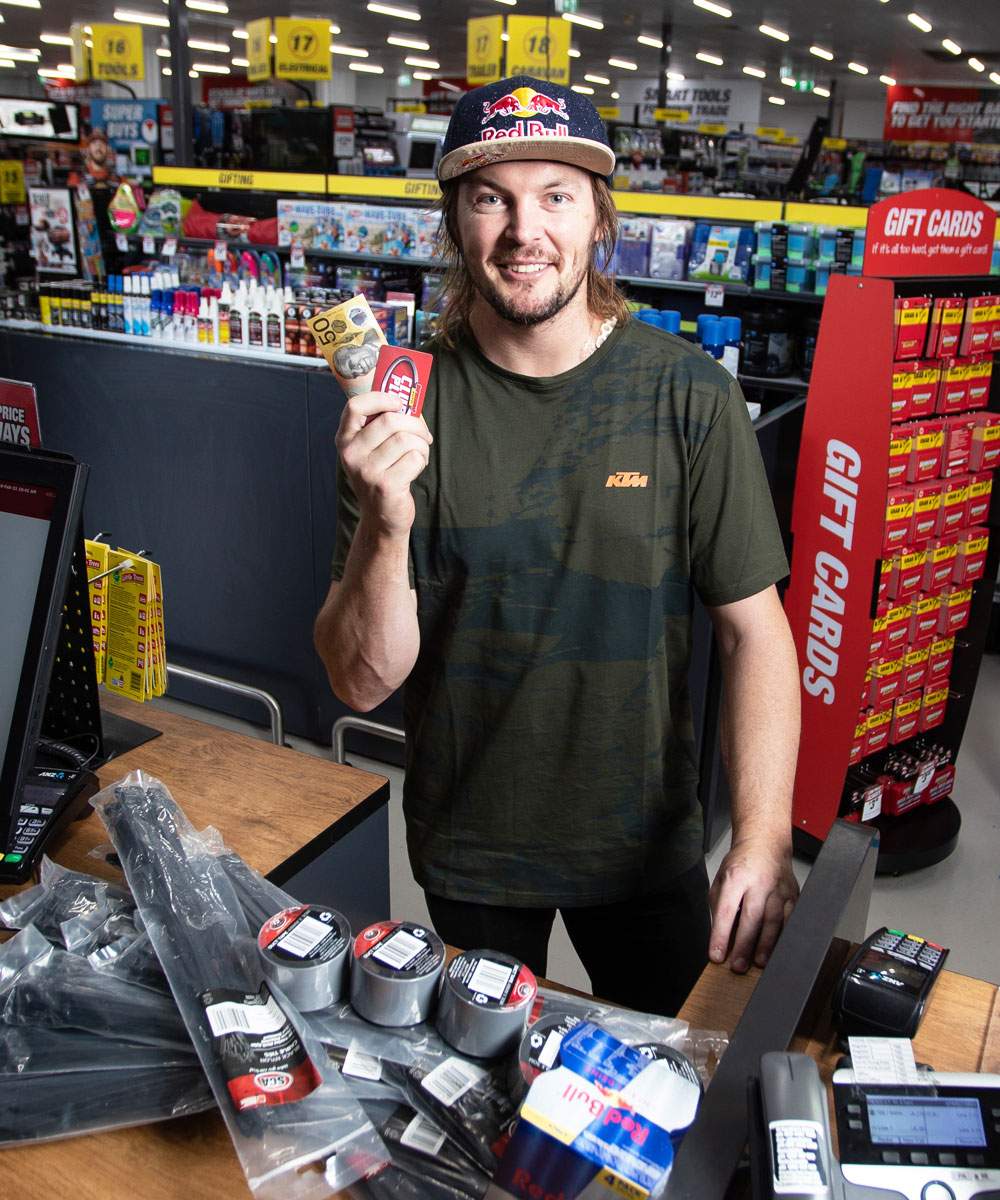 Toby Price holding a Red Bull at the checkout