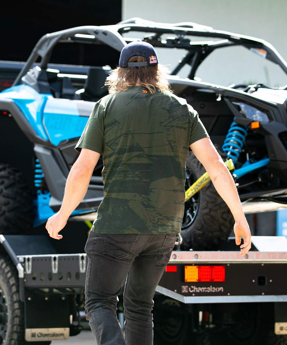 Toby Price walking up to the Can-Am Maverick during the prize pool build
