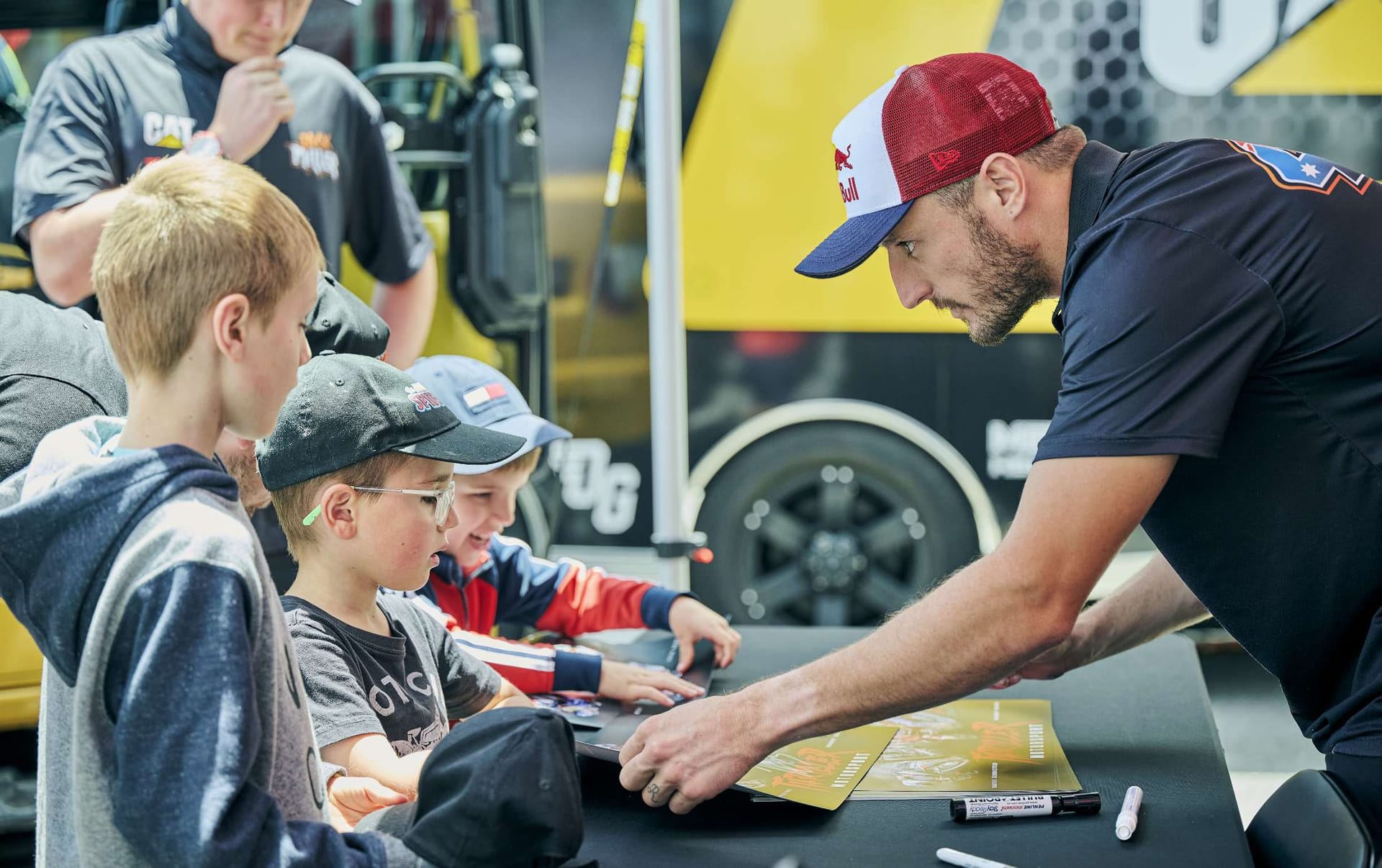 Jack Miller signing merchandise for young fans at The Bend