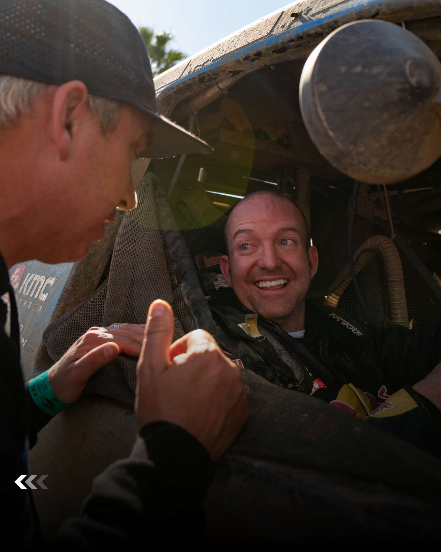 Driver smiling from the cockpit of the Trophy Truck