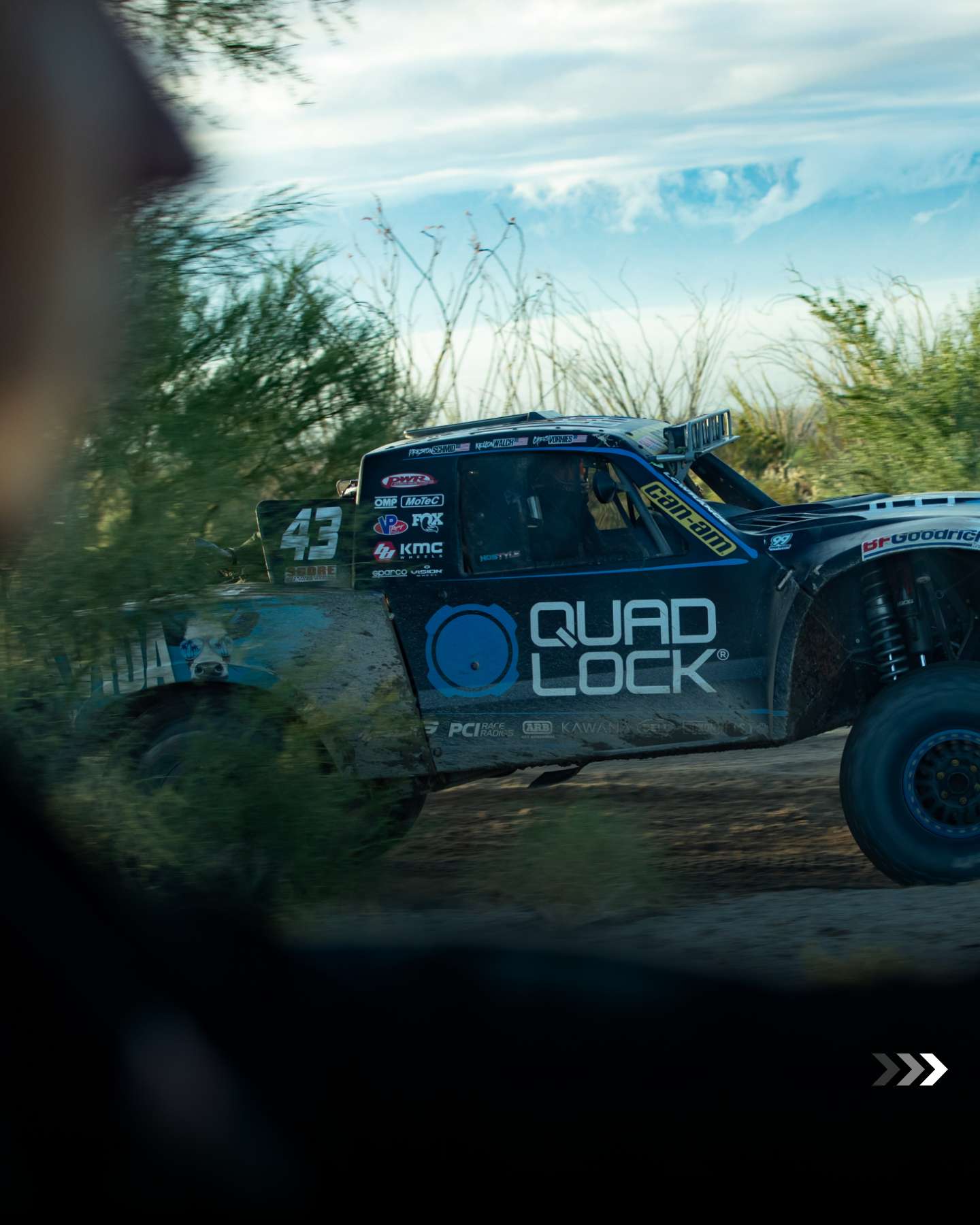 Quad Lock-liveried Team Australia Trophy Truck in the Baja scrub