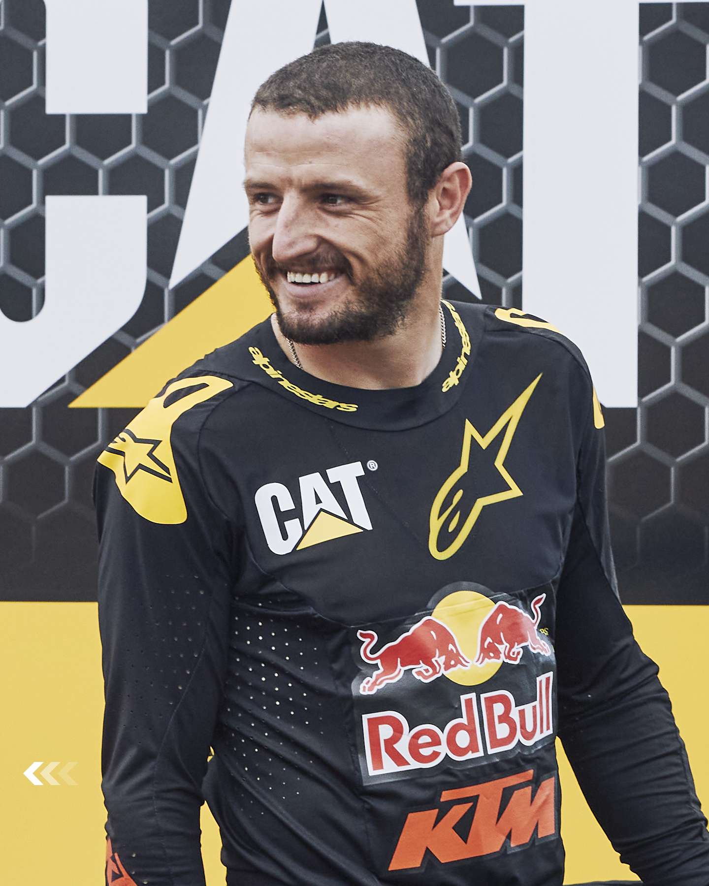 Jack Miller smiling in his Cat and Red Bull riding kit