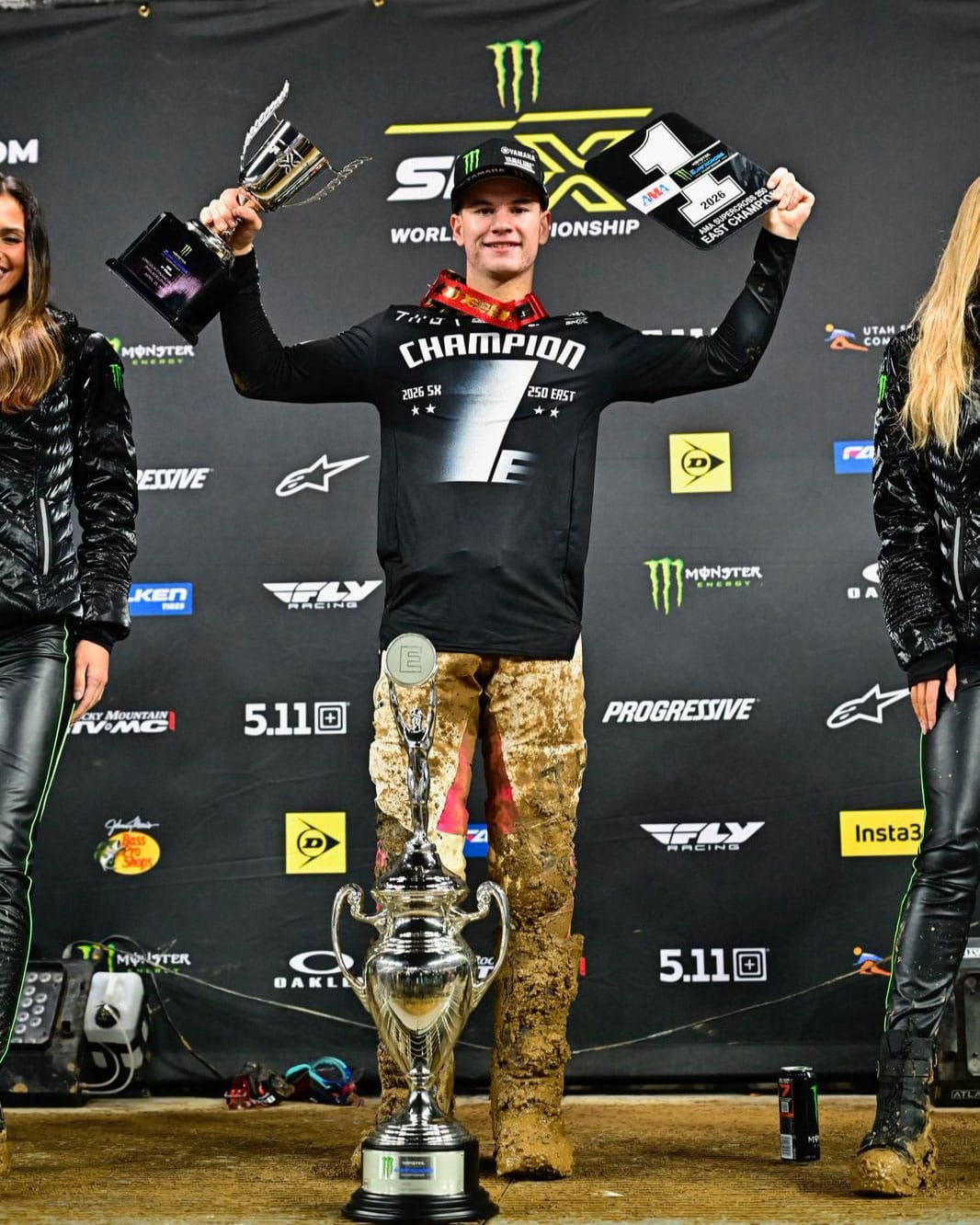 Cole Davies on the podium holding his 250SX East Championship trophies